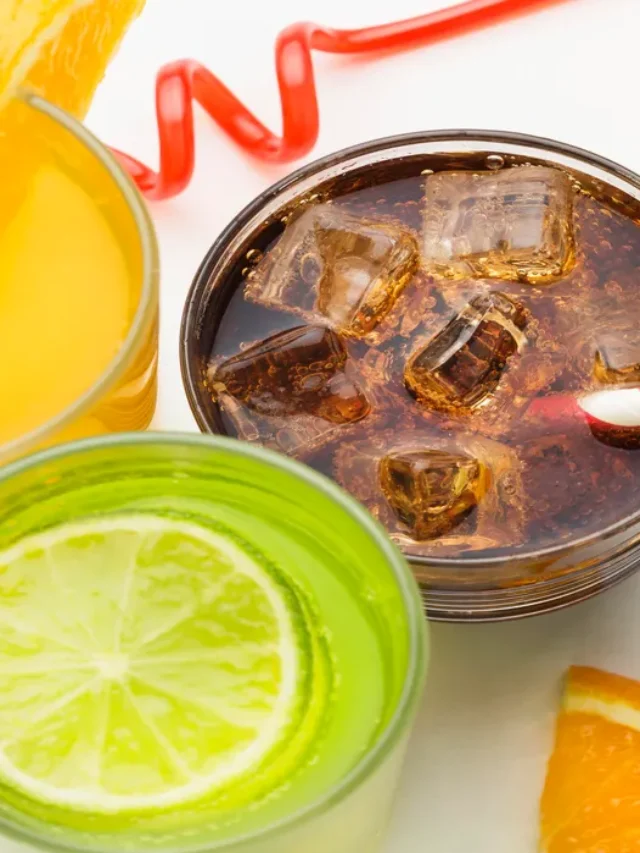 high-angle-glasses-with-soft-drink-fruit-juice-with-straws